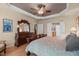 Main bedroom with tray ceiling, ensuite bathroom access, and classic decor at 1105 Ventnor Pl, Cary, NC 27519