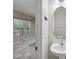 Half bathroom with tiled floor and oval mirror at 11817 Canemount St, Raleigh, NC 27614