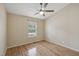 Hardwood floors, ceiling fan, and natural light define this cozy bedroom at 11817 Canemount St, Raleigh, NC 27614