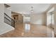 Living room with hardwood floors, a staircase, and a partial view of the kitchen at 11817 Canemount St, Raleigh, NC 27614