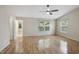 Spacious bedroom with hardwood floors, ceiling fan, and ensuite bathroom at 11817 Canemount St, Raleigh, NC 27614