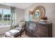 Cozy bedroom corner with a window, armchair, and dresser at 119 Ethel Ln, Angier, NC 27501