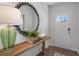 Welcoming foyer with decorative mirror, console table, and entryway door with window at 119 Ethel Ln, Angier, NC 27501