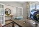 Bright home office with French doors, a wooden desk, and a view of greenery at 119 Ethel Ln, Angier, NC 27501