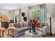 Living room with plush seating, stylish decor, and access to dining area at 119 Ethel Ln, Angier, NC 27501