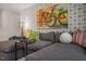 Cozy living room with a large sectional sofa, patterned accent wall, and unique artwork at 119 Ethel Ln, Angier, NC 27501