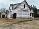 A two-story home under construction with exposed framing and a brick facade at 136 Bar Code Ct, Wendell, NC 27591