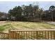 Spacious backyard bordered by trees, viewed from a wooden deck at 193 Magnolia Run Way, Benson, NC 27504