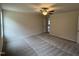 Large bedroom with carpet flooring, ceiling fan, and open doorway to an adjacent room at 193 Magnolia Run Way, Benson, NC 27504