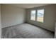 Another bedroom with carpet and two windows at 193 Magnolia Run Way, Benson, NC 27504