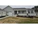 New construction home with gray siding, white trim, and covered front porch at 193 Magnolia Run Way, Benson, NC 27504