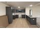 Spacious kitchen featuring gray shaker cabinets, granite counters, and wood-look flooring at 193 Magnolia Run Way, Benson, NC 27504