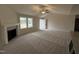 Spacious living room with fireplace, ceiling fan, and plush carpet at 193 Magnolia Run Way, Benson, NC 27504
