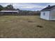 Spacious backyard with a small storage shed and a wooden fence at 206 West Rd, Angier, NC 27501