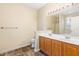 Double vanity bathroom with oak cabinets, tiled flooring, and a separate shower and tub at 2204 Regent Ct, Creedmoor, NC 27522