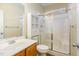 Bathroom with glass shower enclosure, oak vanity, and tile flooring at 2204 Regent Ct, Creedmoor, NC 27522