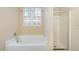 Clean bathroom featuring a separate shower and tub, window with decorative film, and tile floor at 2204 Regent Ct, Creedmoor, NC 27522