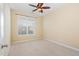 Bright, carpeted bedroom with a large window and ceiling fan at 2204 Regent Ct, Creedmoor, NC 27522