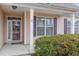 Covered front porch with columns and glass front door, accented by purple shutters at 2204 Regent Ct, Creedmoor, NC 27522