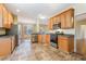 Kitchen featuring oak cabinets, stainless steel appliances, and tile flooring at 2204 Regent Ct, Creedmoor, NC 27522
