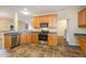 Modern kitchen with stainless steel appliances, oak cabinetry, and ample counter space at 2204 Regent Ct, Creedmoor, NC 27522