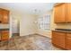 Bright kitchen with tile floors, oak cabinets, and stainless steel appliances at 2204 Regent Ct, Creedmoor, NC 27522