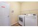 Laundry room with washer and dryer, overhead shelf, and tile flooring at 2204 Regent Ct, Creedmoor, NC 27522