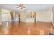 Open-concept living area with hardwood flooring, ceiling fan, and view of the kitchen at 2204 Regent Ct, Creedmoor, NC 27522