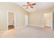 Large main bedroom with ensuite bathroom access, carpeted flooring, and neutral decor at 2204 Regent Ct, Creedmoor, NC 27522