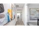 Hallway with wood-look flooring and modern artwork leading to a dining area at 222 Leven Dr, Gibsonville, NC 27249