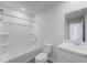 Clean bathroom with white tub, marble vanity, and white cabinets at 228 Maggie Ln, Roxboro, NC 27573