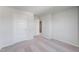 Empty bedroom with carpet, white walls, and two white doors at 228 Maggie Ln, Roxboro, NC 27573