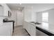 Bright, modern kitchen with white cabinets, stainless steel appliances, and sleek countertops at 228 Maggie Ln, Roxboro, NC 27573