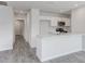 White kitchen with marble countertops, stainless steel appliances, and gray wood-look flooring at 228 Maggie Ln, Roxboro, NC 27573