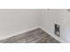 Laundry room with wood-look flooring and laundry chute access at 228 Maggie Ln, Roxboro, NC 27573