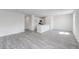 Living area with gray flooring, a kitchen island, and access to another room at 228 Maggie Ln, Roxboro, NC 27573