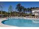 Neighborhood pool with ample lounge chairs, umbrellas, and nearby clubhouse at 2308 Beeblossom Pl, Fuquay Varina, NC 27526