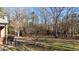 Spacious backyard with a mix of grass, trees, and a small ornamental tree at 25 Sylvan Way, Zebulon, NC 27597