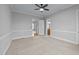 A bedroom featuring carpeted floors, a ceiling fan, and an ensuite bathroom at 25 Sylvan Way, Zebulon, NC 27597