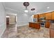 Bright kitchen with tile floor, large island, and wood cabinetry at 25 Sylvan Way, Zebulon, NC 27597