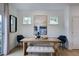 Dining area with a wooden table, bench, and stylish chairs in front of a large artwork at 26 Shay St, Angier, NC 27501