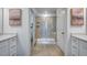 Main bathroom featuring a glass shower, dual vanities, and contemporary finishes at 26 Shay St, Angier, NC 27501