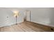 Bedroom with hardwood floors, a lamp, and open doorways at 320 W Orange St, Hillsborough, NC 27278