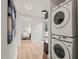 Laundry area with stacked washer and dryer, and a view down the hallway at 320 W Orange St, Hillsborough, NC 27278