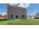 Back exterior of a two-story home with sliding glass doors and a grassy lawn at 432 Ashley Run, Sanford, NC 27330