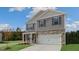 New two-story home with stone accents, front porch, and attached two-car garage at 432 Ashley Run, Sanford, NC 27330