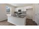 Modern kitchen with white cabinets, dark granite countertops, and stainless steel appliances at 432 Ashley Run, Sanford, NC 27330
