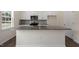 Kitchen island with granite countertop, sink, and white cabinets at 432 Ashley Run, Sanford, NC 27330