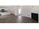 Open living area with wood-look flooring, fireplace, and view of the kitchen at 432 Ashley Run, Sanford, NC 27330