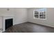 Living room with fireplace, large window, and wood-look flooring at 432 Ashley Run, Sanford, NC 27330